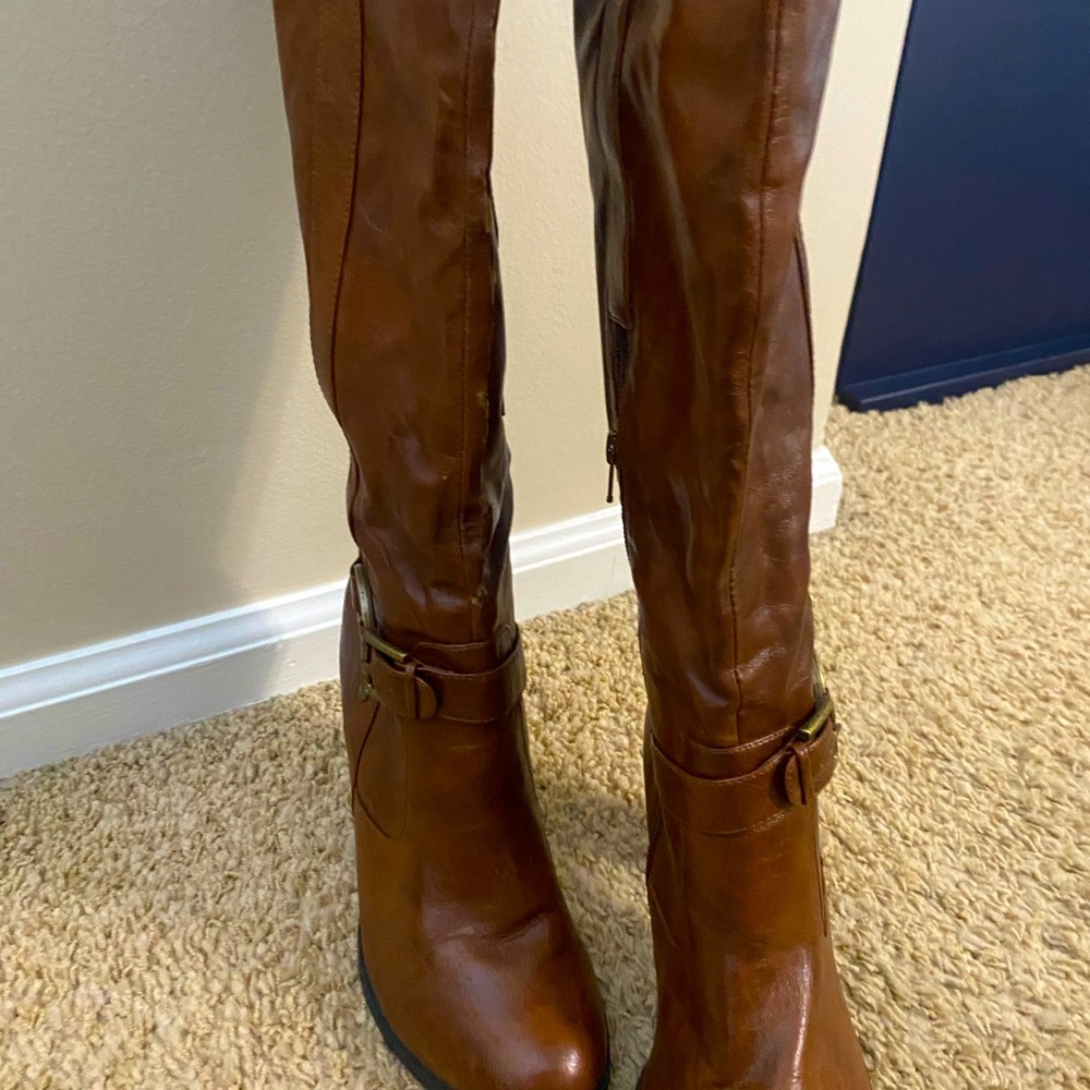 Knee high cognac leather boots with bronze buckle